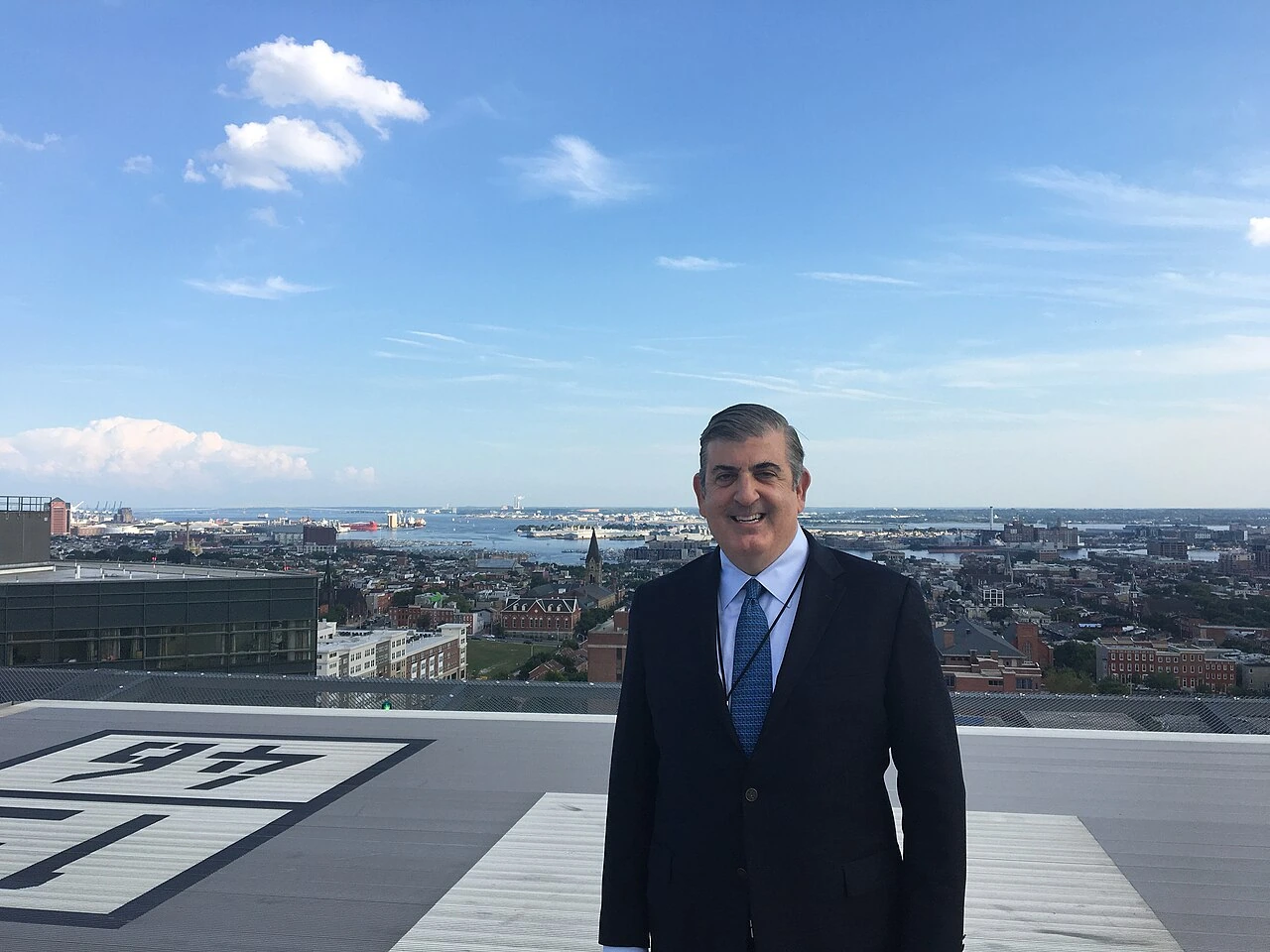Nicholas Theodore standing outdoors with a cityscape in the background at Johns Hopkins Hospital