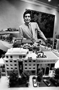 Black-and-white portrait of Bernard Nicod standing behind a scale model of a real-estate development.