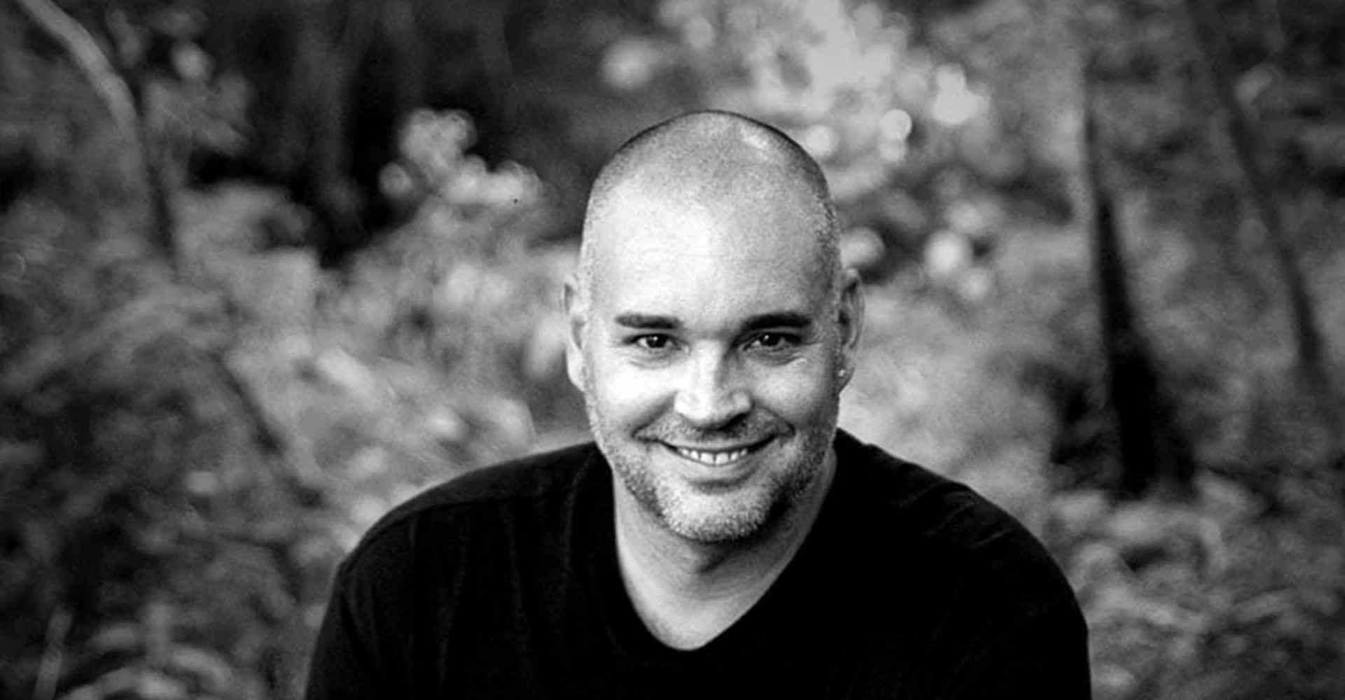 Black-and-white portrait of Nicolas Duvernois smiling outdoors