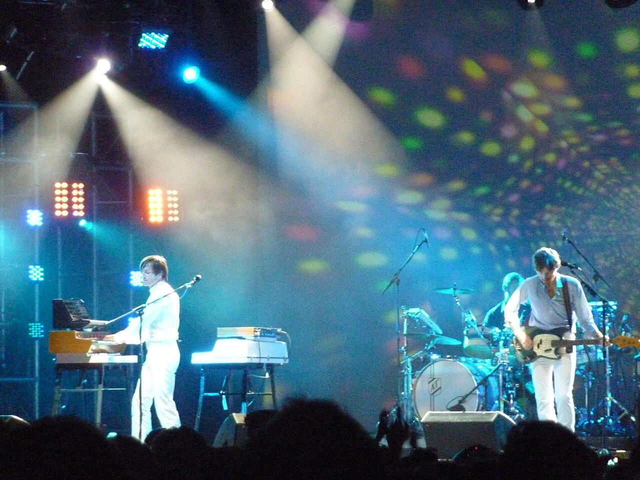 Air performing live on stage, with Nicolas Godin at keyboards on the left and another band member on guitar to the right