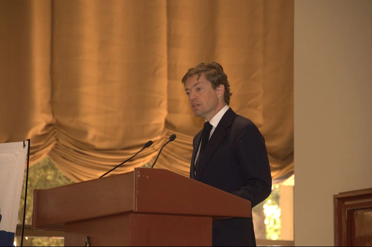 Nicolas Berggruen speaking at a podium in a formal setting