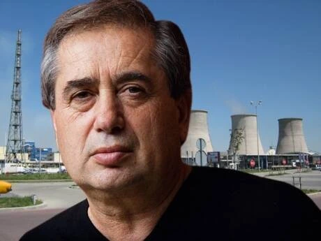 Ioan Niculae standing outdoors in front of an industrial plant, portrait photo.